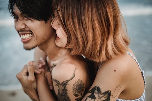Free Couple Embracing from Behind Stock Photo