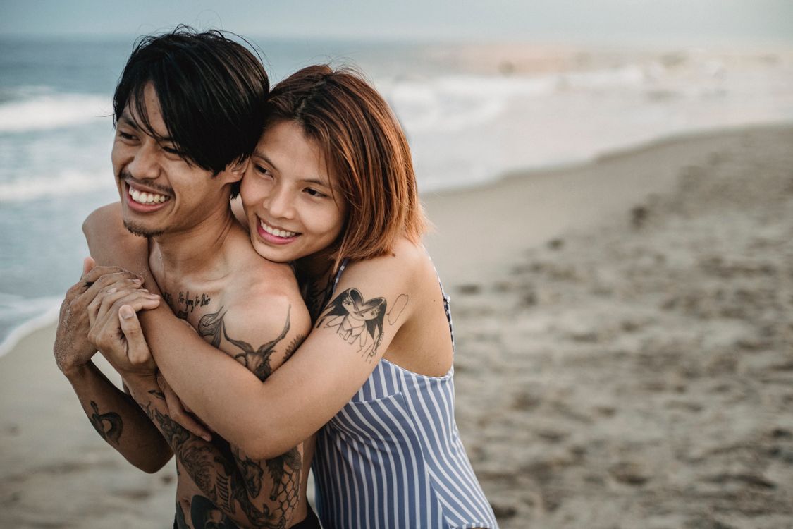 Woman and Man Hugging on Beach · Free Stock Photo