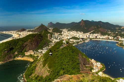 Free A breathtaking aerial view of Rio de Janeiro showcasing Sugarloaf Mountain and the city's coastline. Stock Photo
