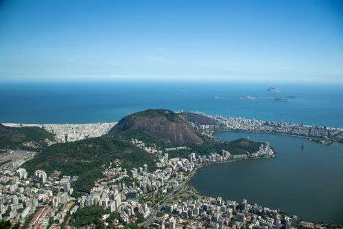 Free Stunning aerial image capturing Rio de Janeiro's coastline, showcasing mountains, city, and ocean. Stock Photo