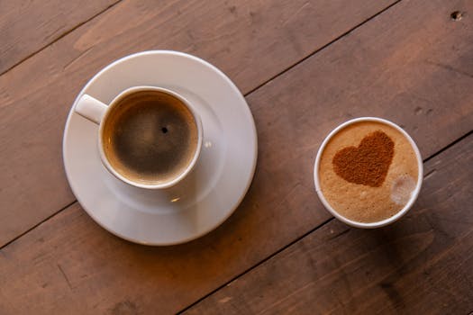 Top view of a cappuccino with heart design and espresso on a rustic table, perfect for coffee lovers