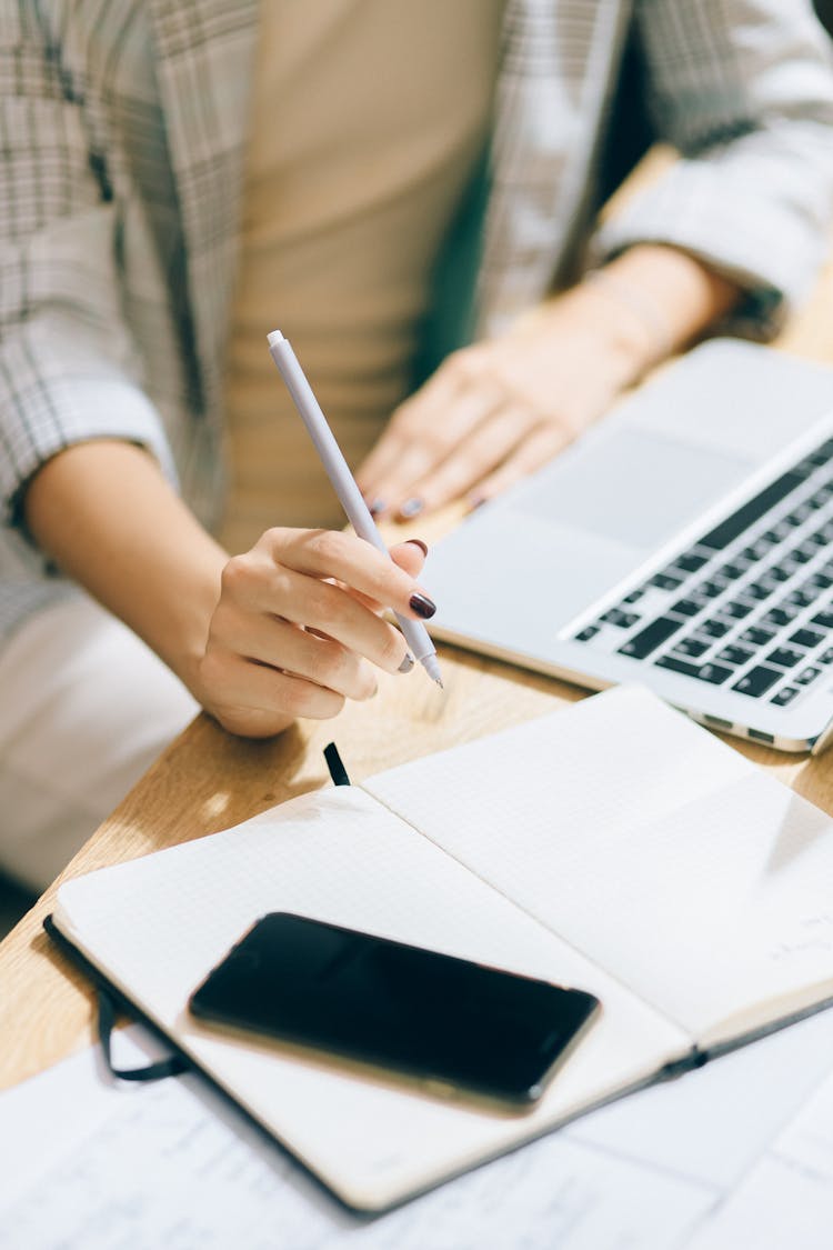 Person Holding A Pen