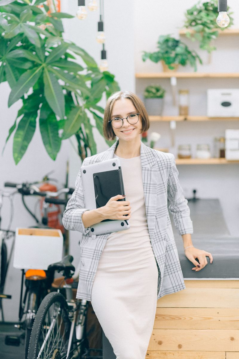A founder smiling while working on her laptop