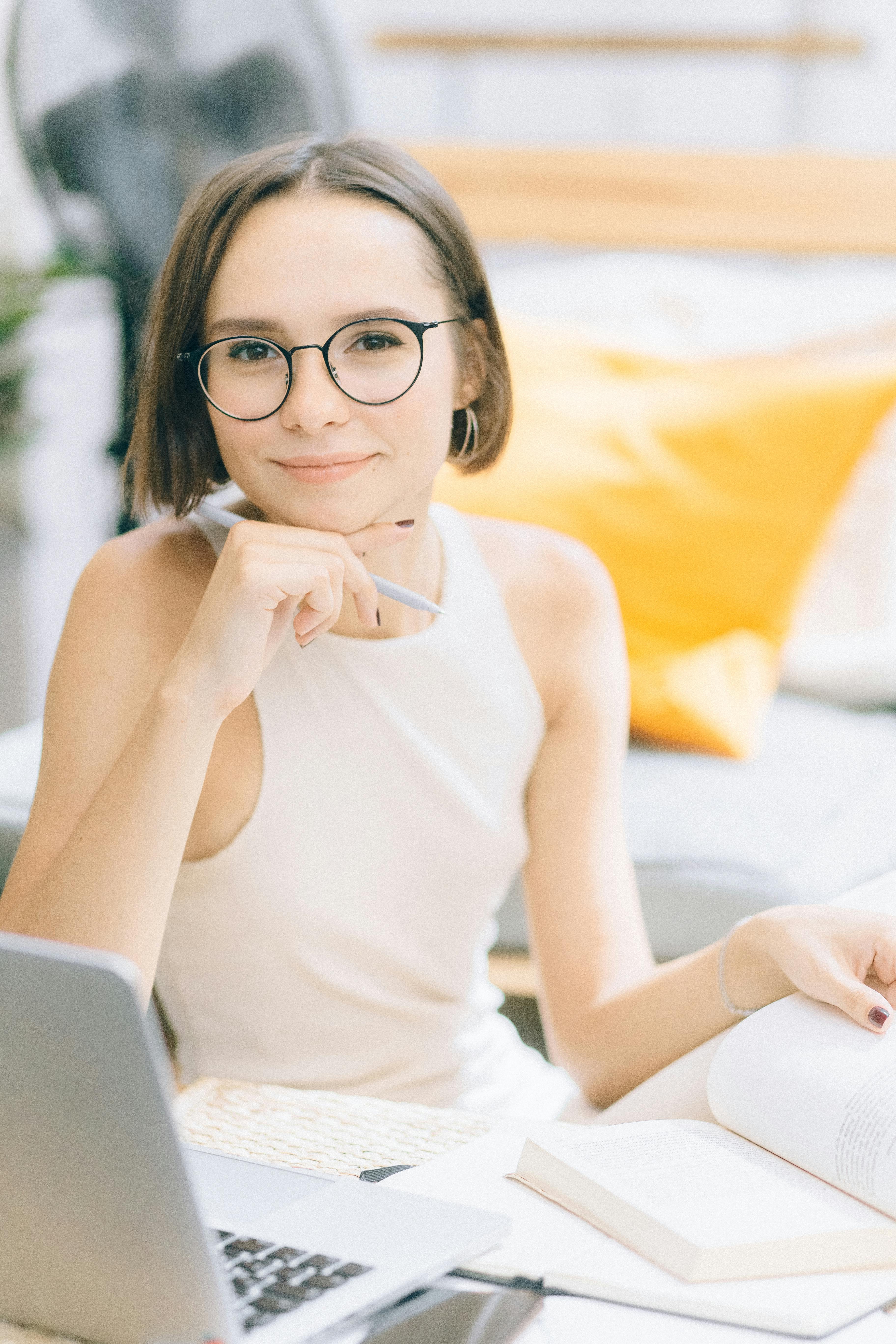 Woman in White Tank Top Wearing Black Framed Eyeglasses · Free Stock Photo
