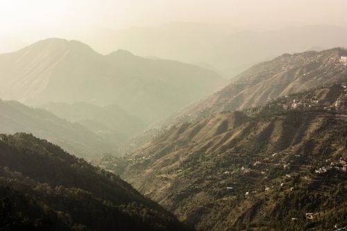 Free Beautiful aerial panorama of the misty mountains in Shimla, India at sunset. Stock Photo