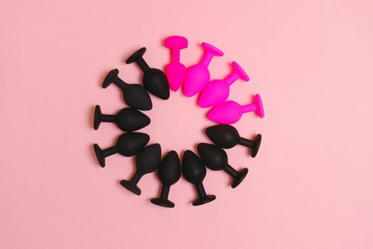 Colorful silicone plugs arranged in a circle on a pink surface, offering a stylish presentation.