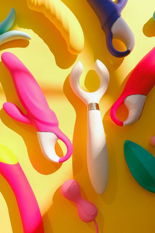 Free Sex Toys on a Yellow Background Stock Photo