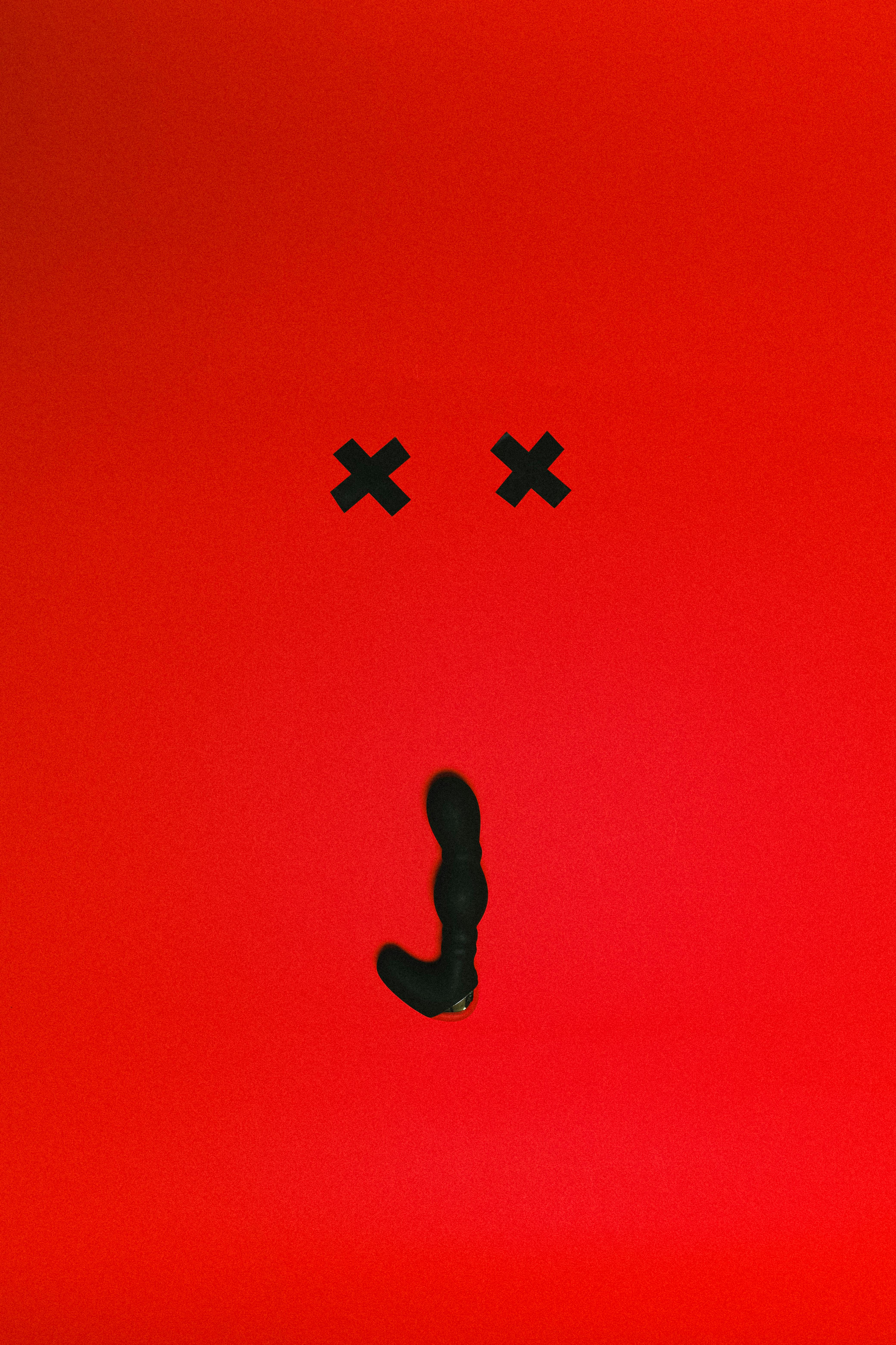 black sex toy on red background