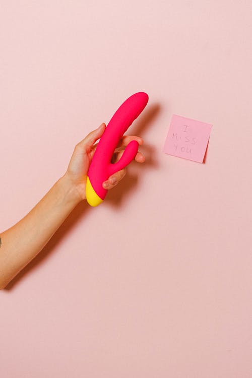 Free Hand Holding a Sex Toy Stock Photo