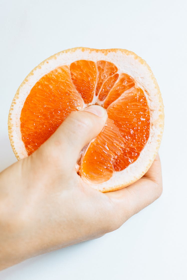 Person Holding Sliced Orange Fruit