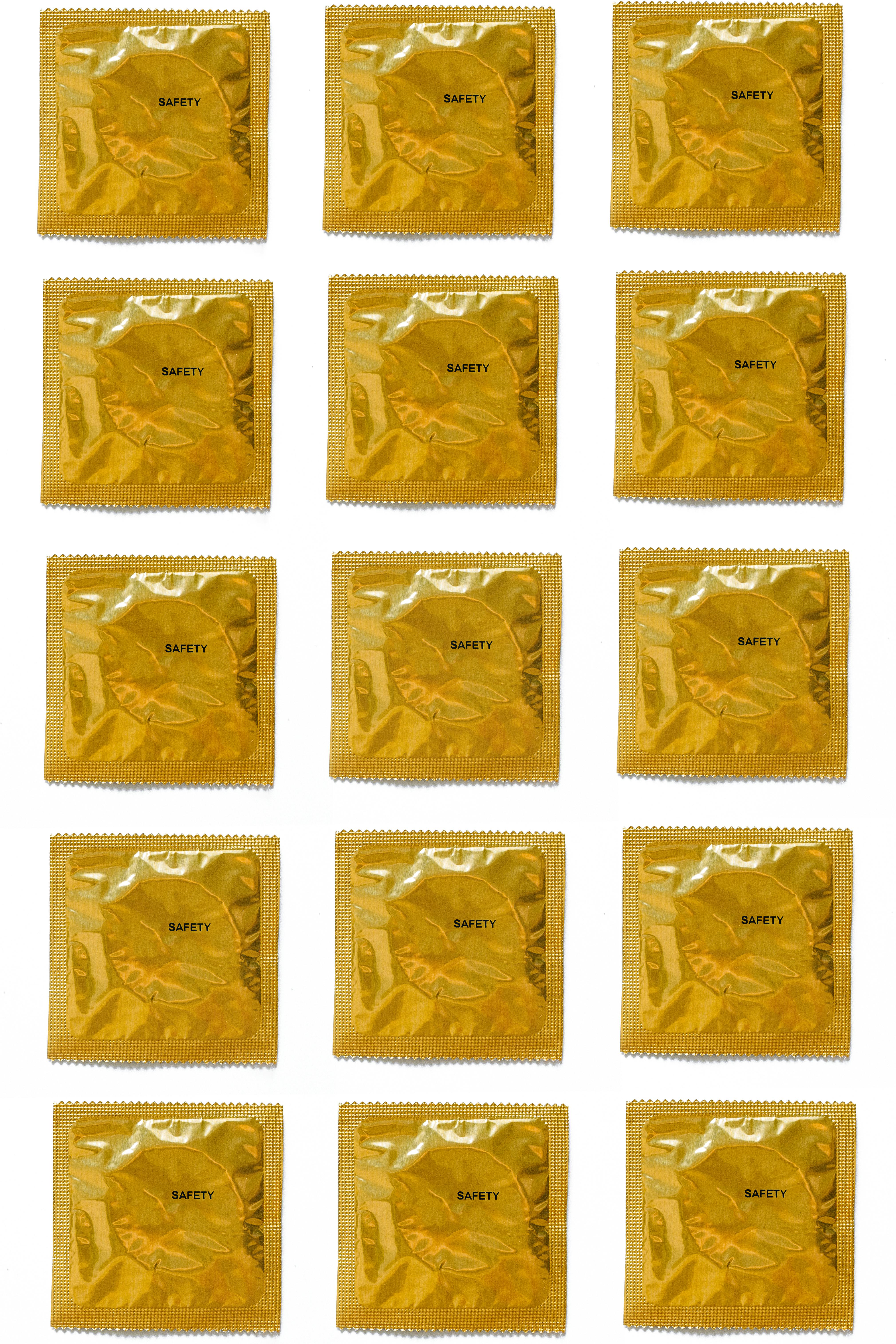 yellow condoms on white background