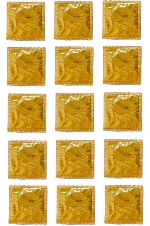 Yellow Condoms on White Background