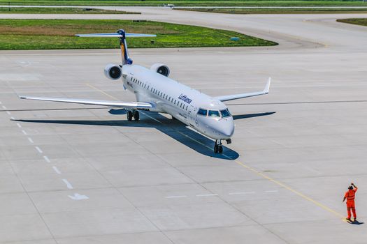 Person Standing in Front of Air Plane