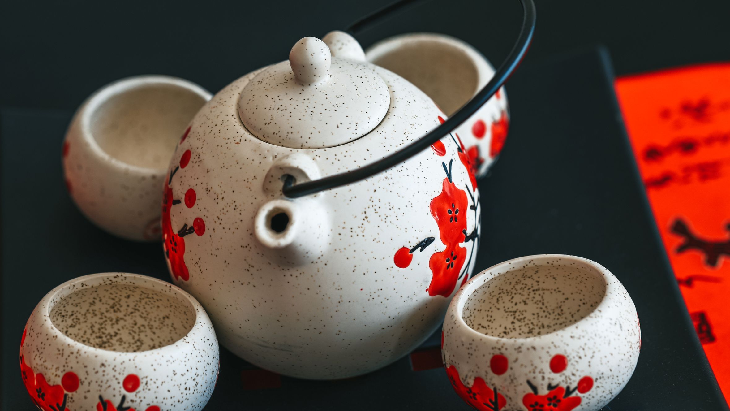 Close-up of a decorative tea set featuring a traditional floral design, ideal for cultural or culinary themes.