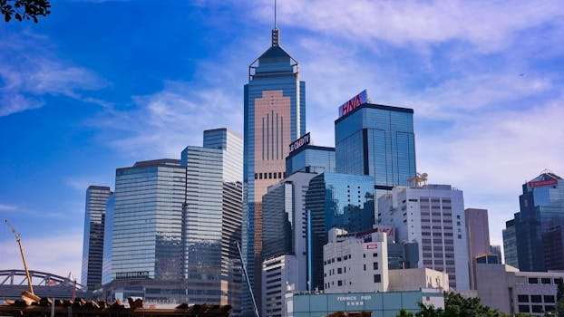 A stunning view of Hong Kong's modern skyscrapers against a clear blue sky.