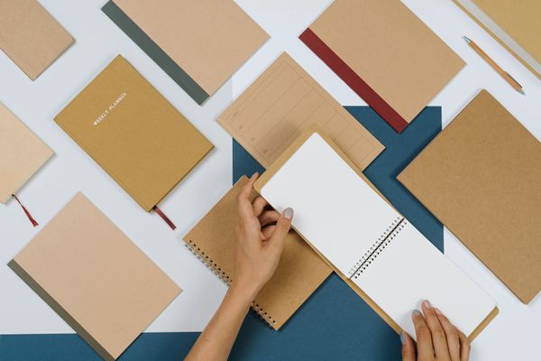 Person flipping pages of a notepad