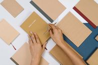 Person Holding Brown and White Paper