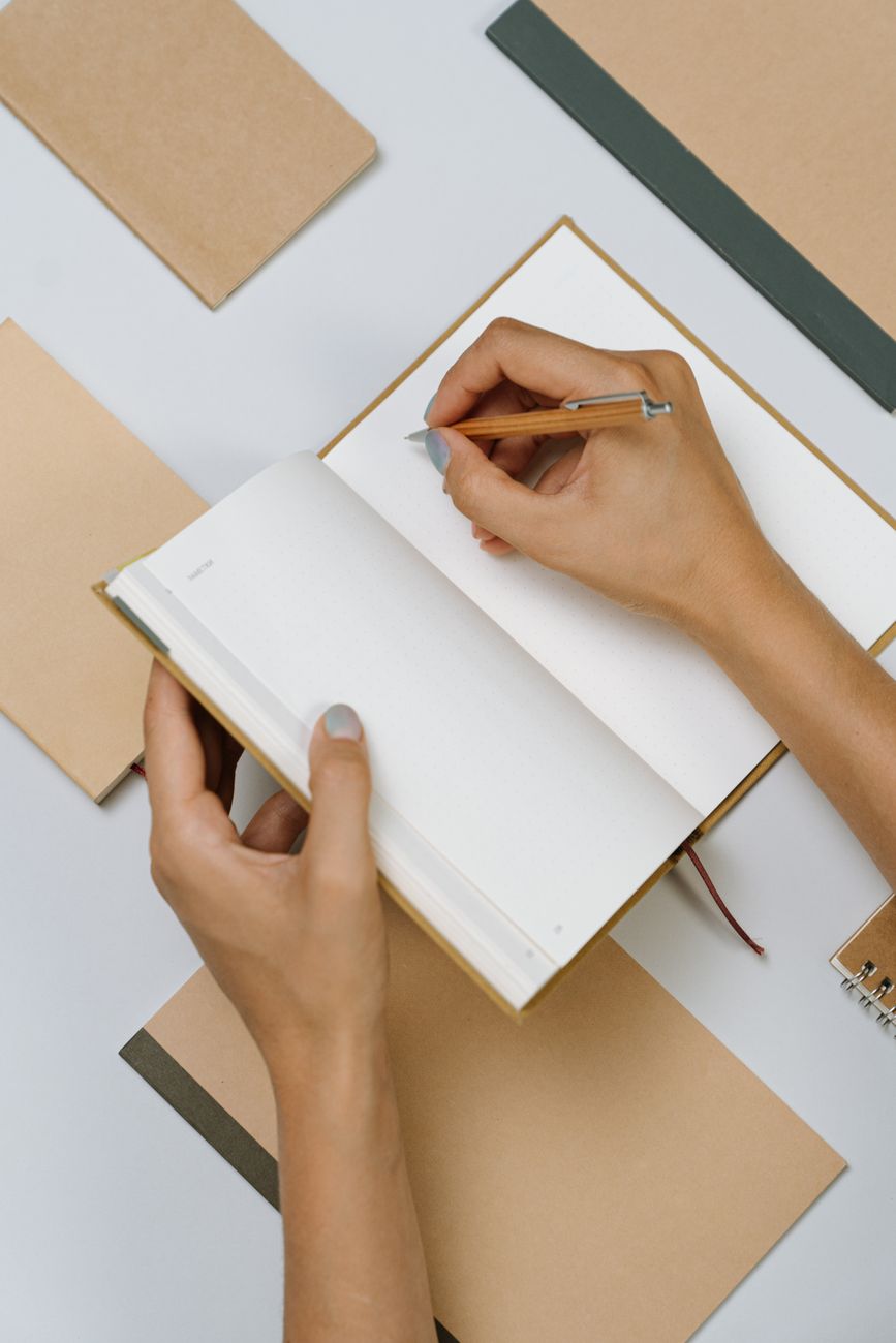 Notebook open with handwritten task list and pen for planning an evaluation