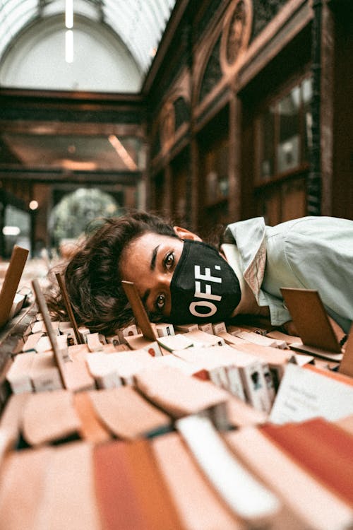 Woman Resting Her Head on Books