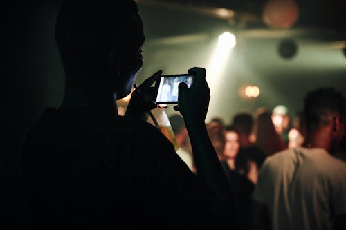 Man Photographing a Concert in a Club 