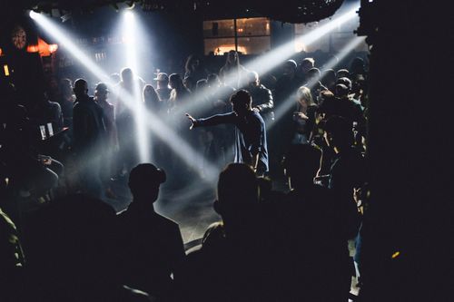 Free Vibrant nightclub scene with people dancing and DJ lighting creating a lively atmosphere. Stock Photo