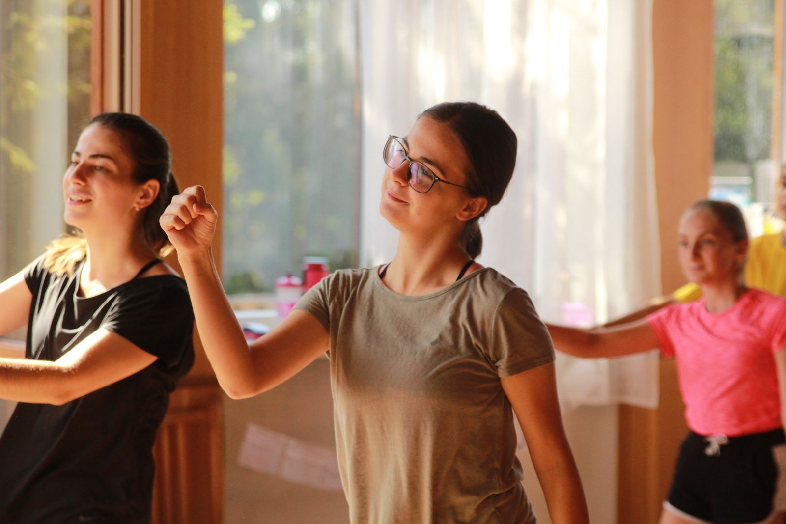 Group of Zumba participants dancing together in an energetic studio session