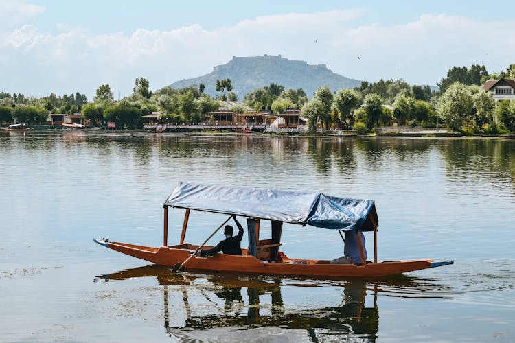 Fisherman Boat On Water In Traditional Asian Village