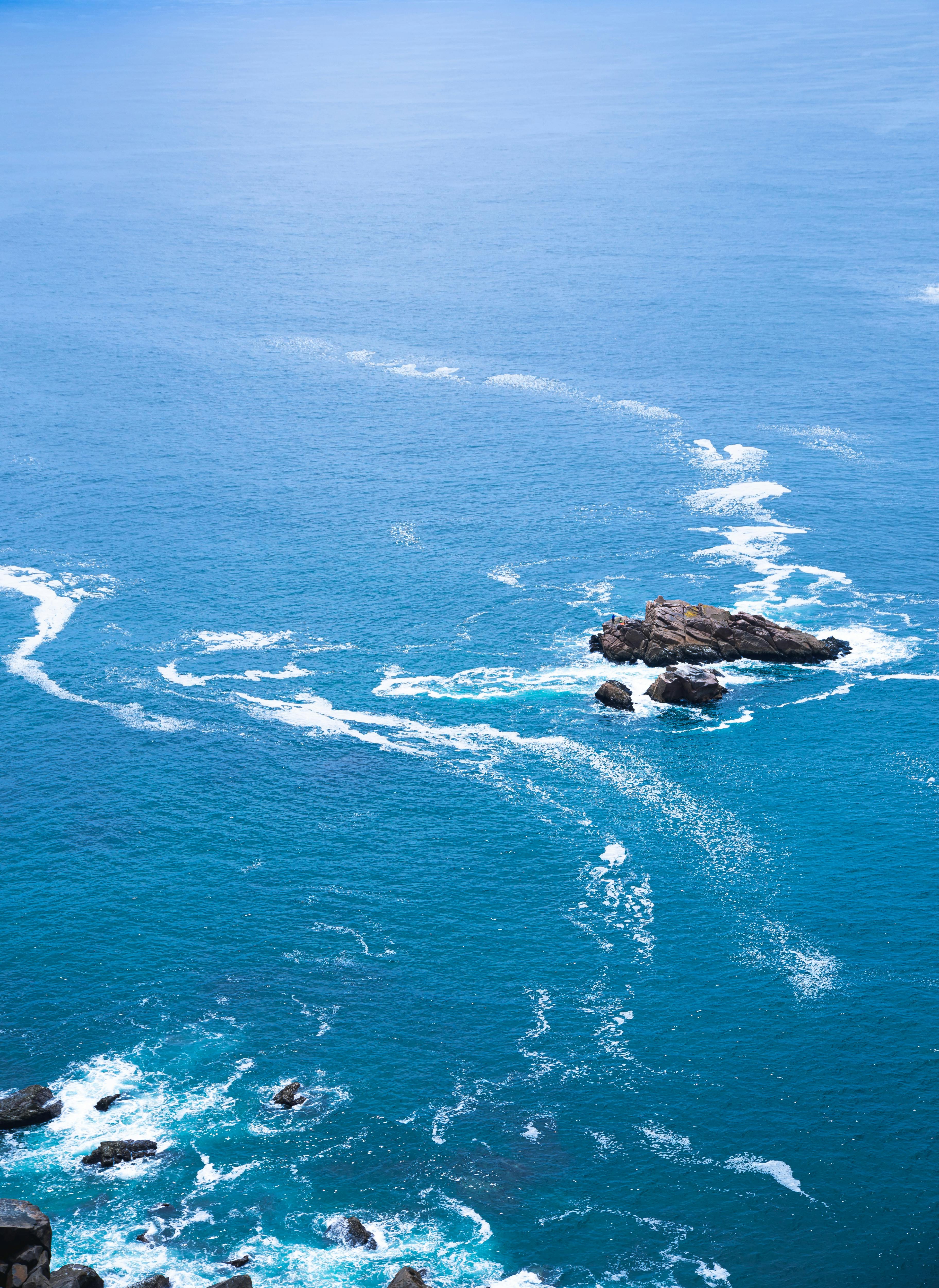 shallow blue sea washing rough rocks