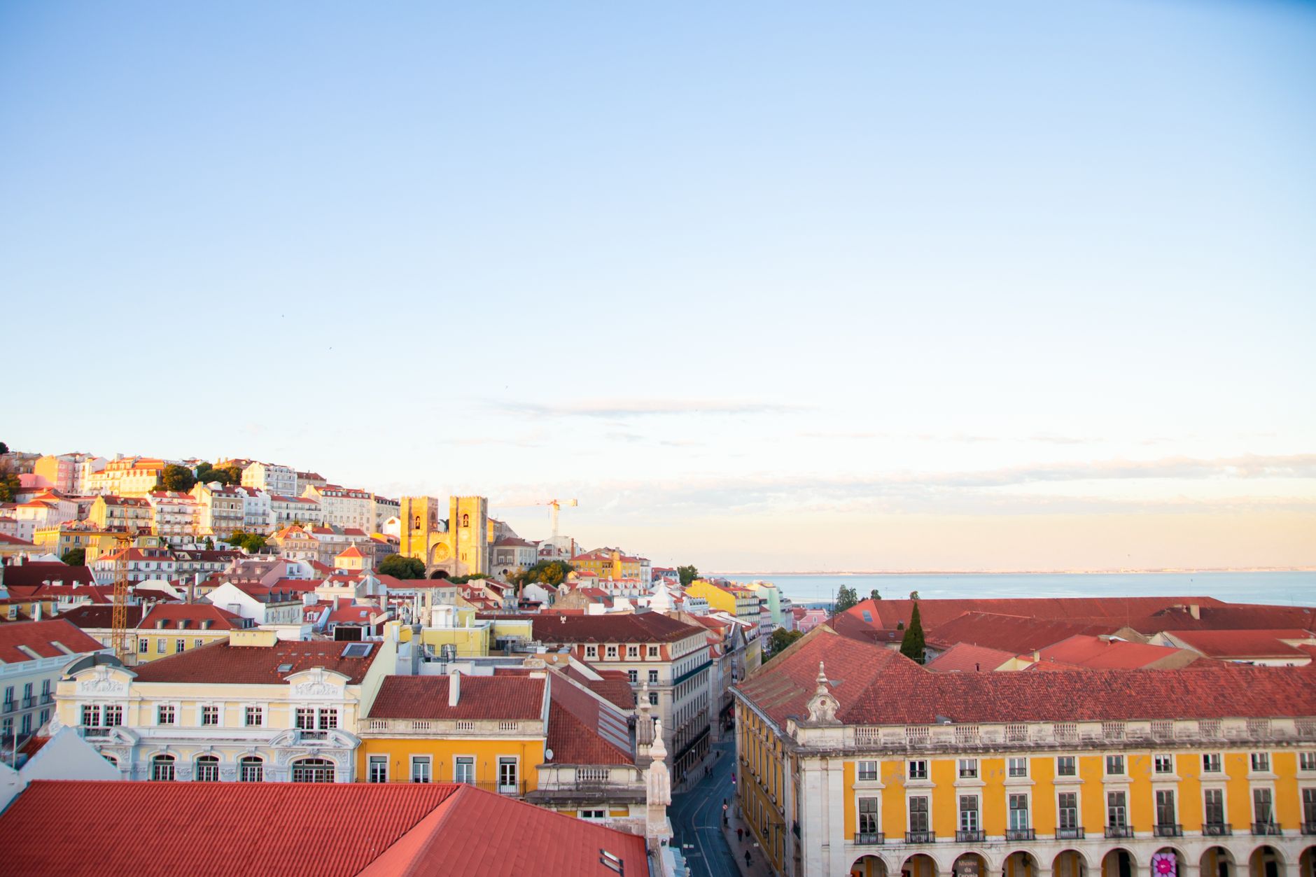 Scenery of modern residential district houses roofs located in Lisbon in early evening under clear blue sky