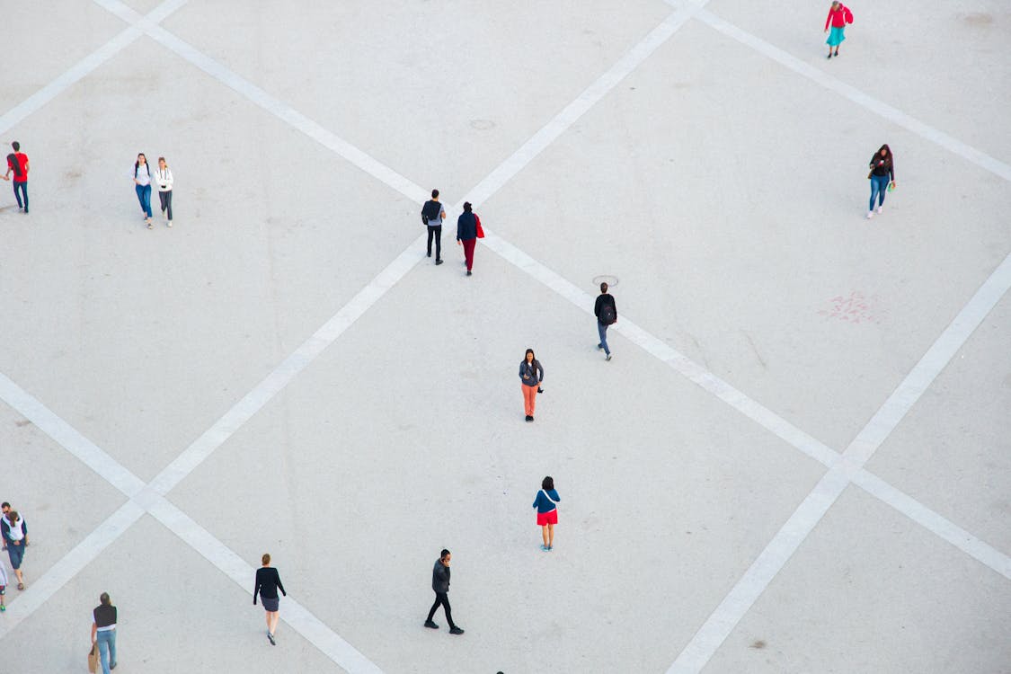 Free High angle citizens in casual wear walking on vast concrete ground in city square Stock Photo