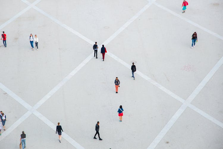 People Walking On Spacious Concrete Square