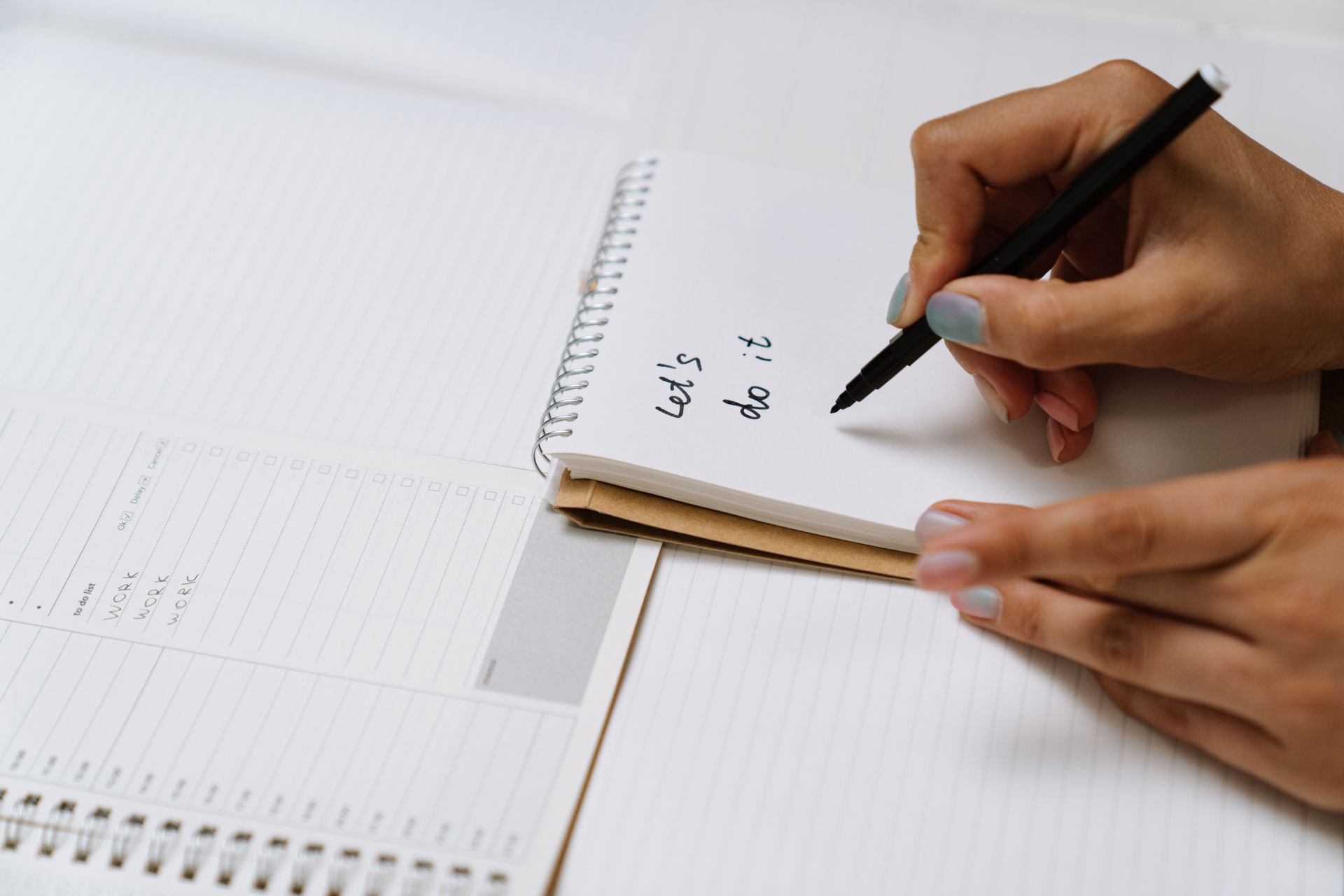 A Person Writing on White Paper