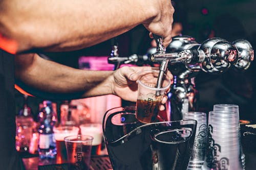 Free Pouring Beer in Nightclub Stock Photo