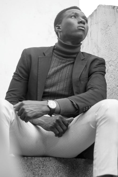Free Black and white portrait of a young man in a suit, expressing confidence and contemplation. Stock Photo
