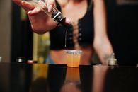 Bartender Pouring Liquor on a Shot Glass
