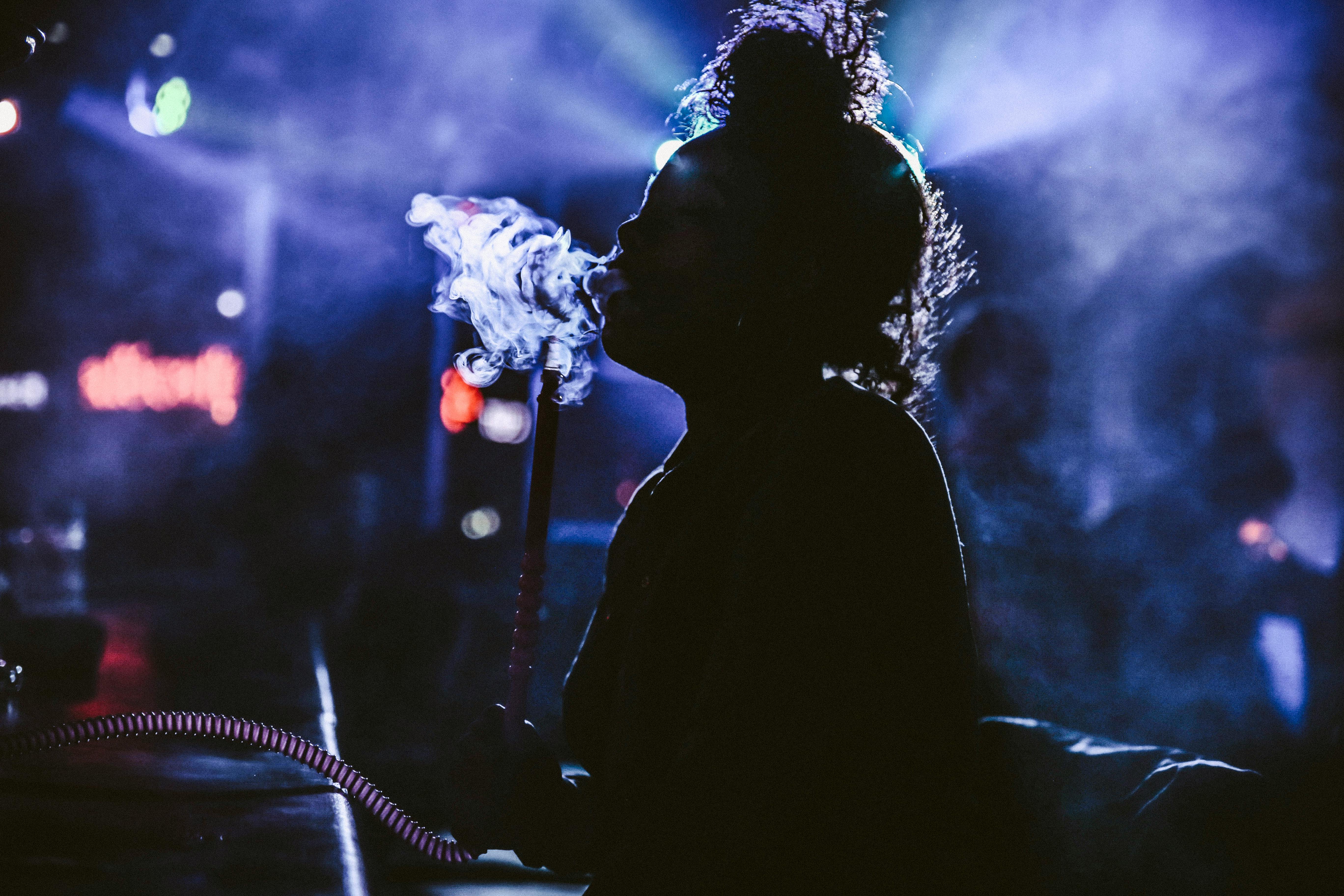 silhouette of a person smoking on shisha