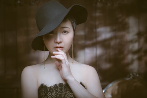 Free Trendy ethnic model in felt hat and golden earrings Stock Photo