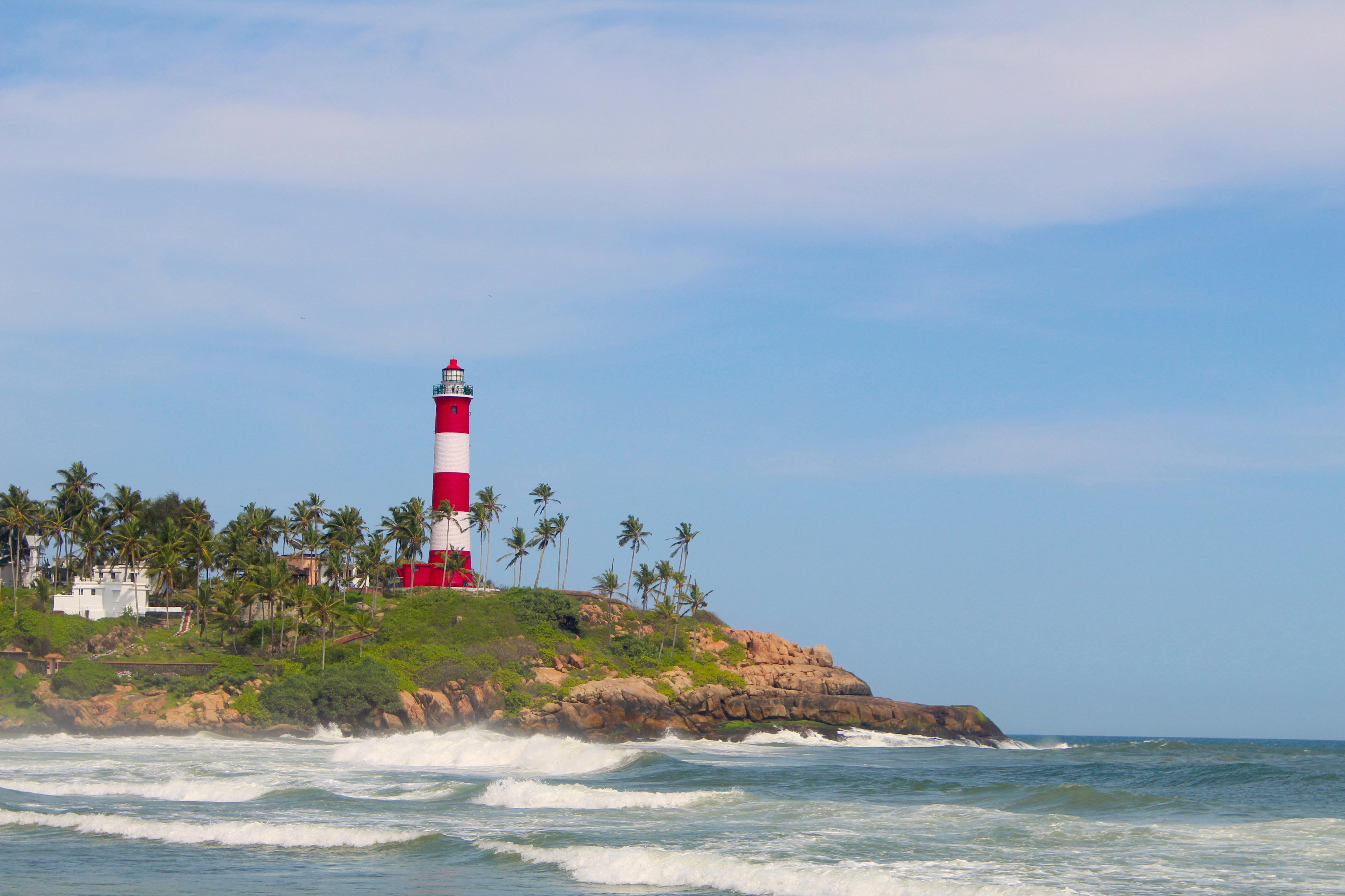 A Lighthouse On Brown Rocky Shore · Free Stock Photo