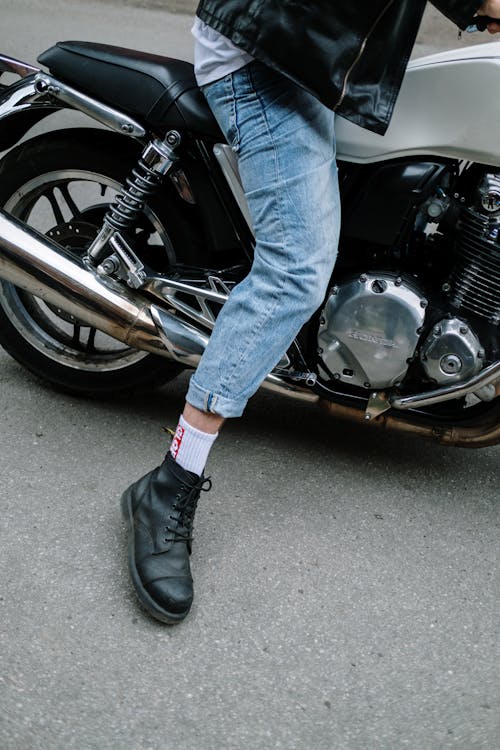 Person Wearing a Denim Jeans Riding a Motorcycle · Free Stock Photo