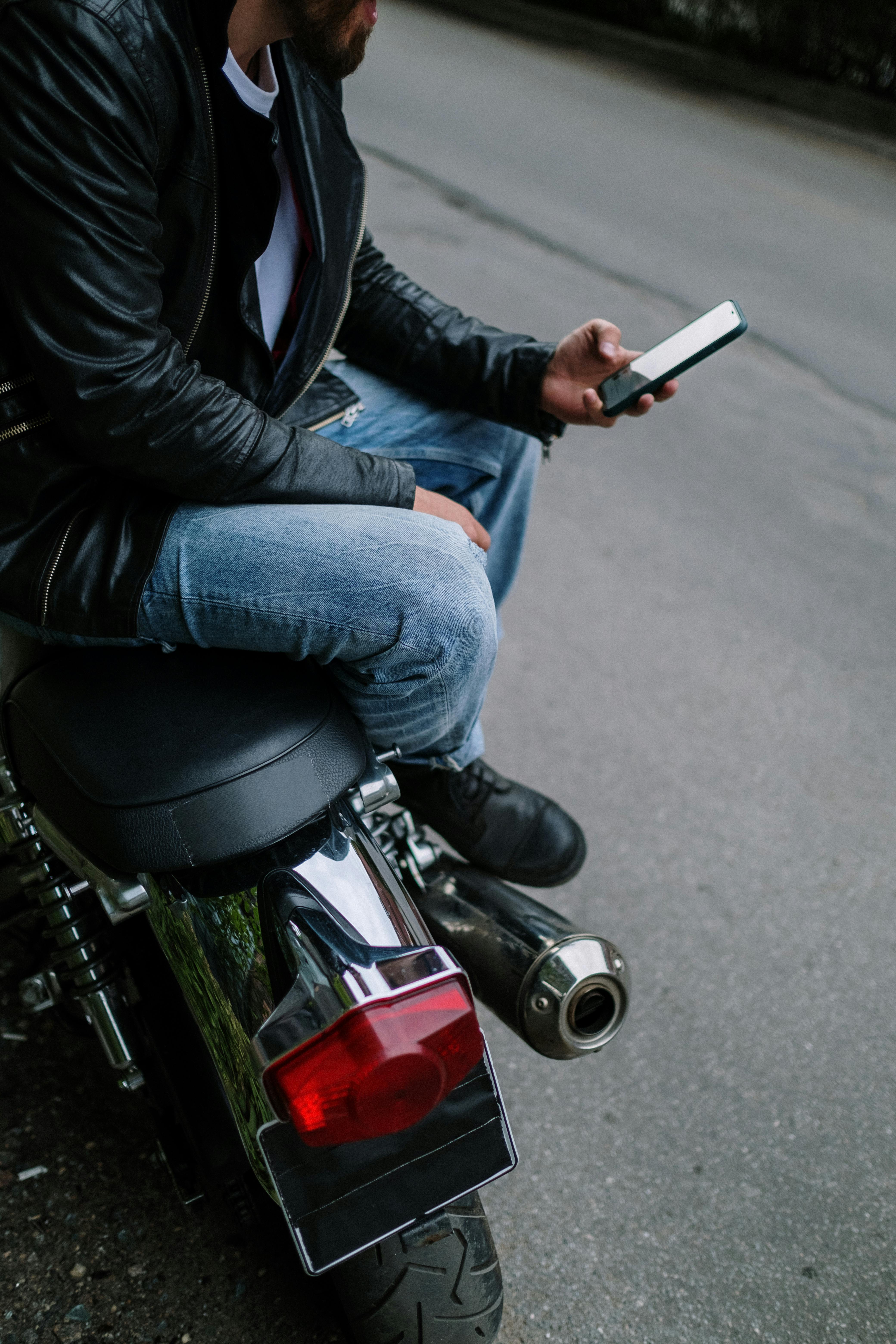A Man in Black Leather Jacket Sitting Beside the Motorbike · Free Stock  Photo