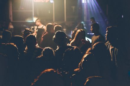 Crowd at a dimly lit live music venue — photo by Maor Attias on Pexels