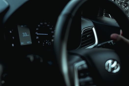 Close-up image of a modern car dashboard and steering wheel interior.