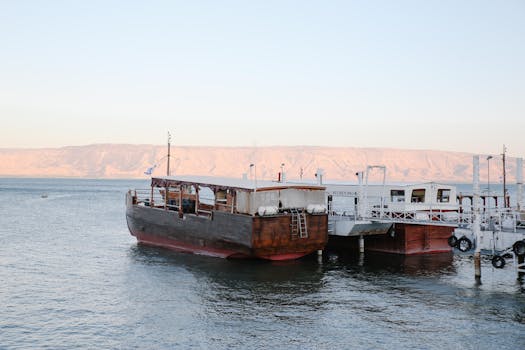 Traditional wooden boats docked at a serene marina in Israel's Sea of Galilee.