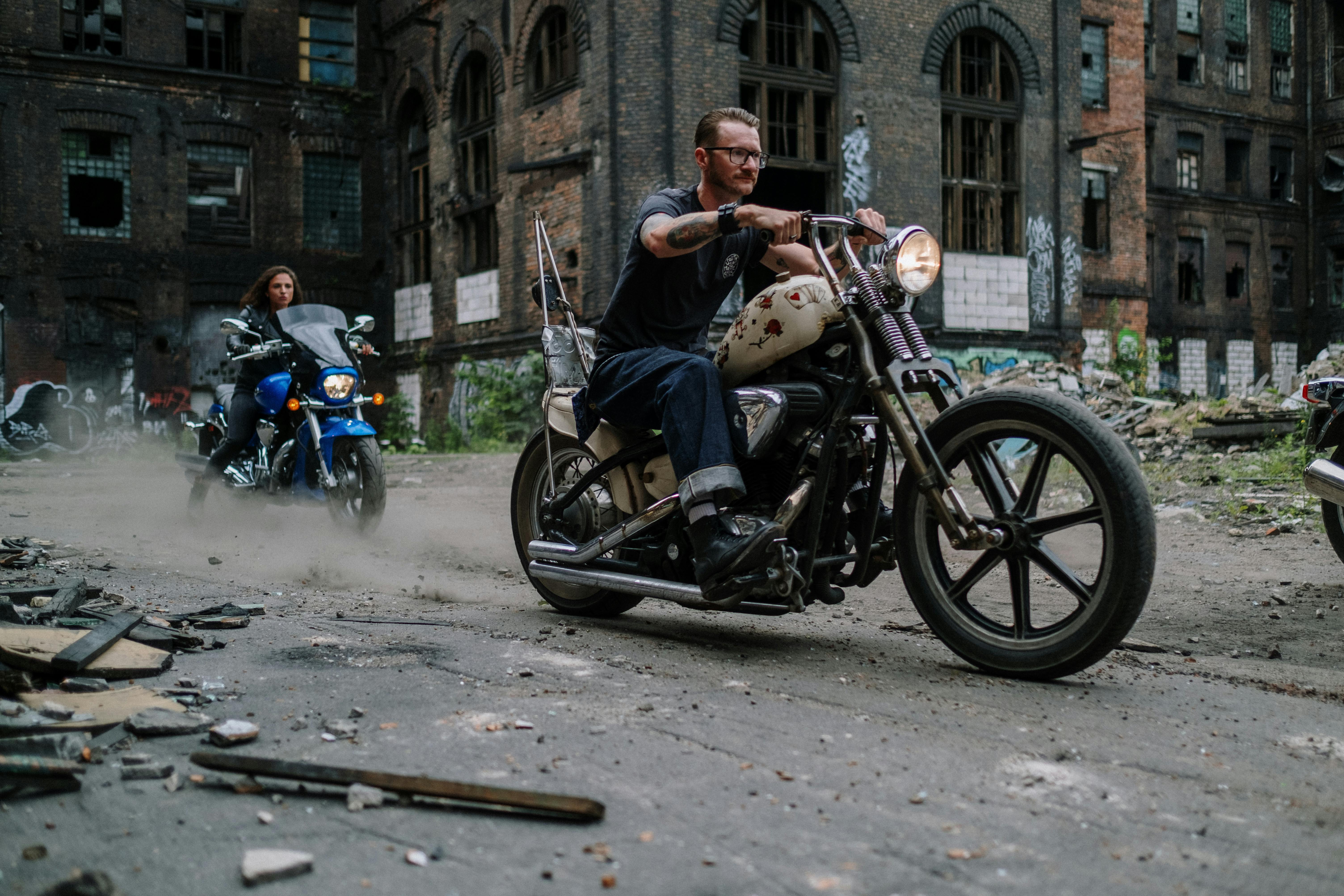 man and woman riding on black motorcycle