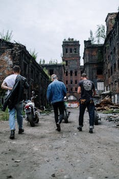 Group of motorcyclists exploring an abandoned industrial site with a sense of freedom and rebellion.