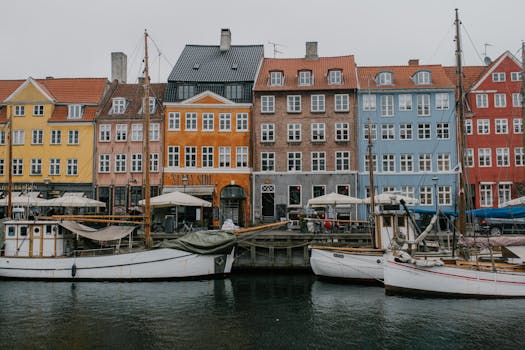 Vibrant view of Nyhavn canal with colorful buildings and boats in Copenhagen, Denmark.