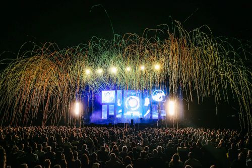 Free A lively concert scene with a colorful audience and bright stage lights at night. Stock Photo
