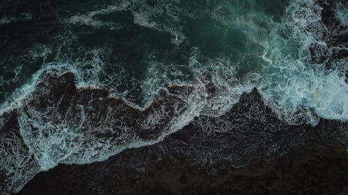 Top View of Waves Crashing on the Seashore