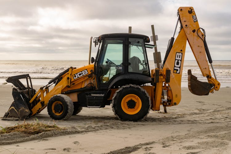 A Backhoe Tractor On A Beach