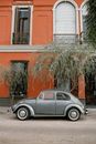 Silver Sedan Parked Beside Brown Concrete Building